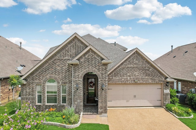 16001 Gladewater Ter, Prosper, TX 75078 - view of front facade featuring brick siding, a shingled roof, a garage, driveway, and cooling unit