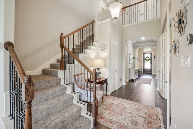16001 Gladewater Ter, Prosper, TX 75078 - foyer with arched walkways, baseboards, a high ceiling, dark wood-type flooring, and stairs