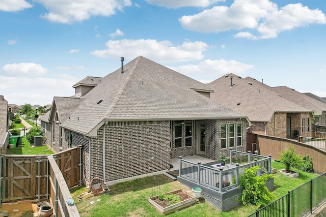 16001 Gladewater Ter, Prosper, TX 75078 - rear view of property featuring roof with shingles, brick siding, a gate, a vegetable garden, and central AC unit