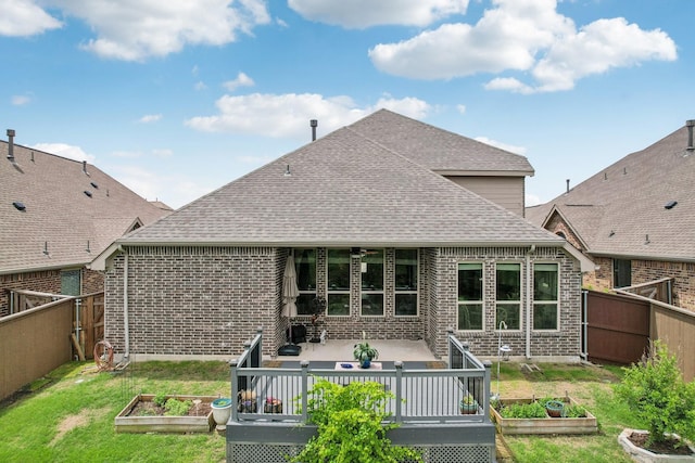 16001 Gladewater Ter, Prosper, TX 75078 - back of property featuring a garden, brick siding, a shingled roof, and a patio area