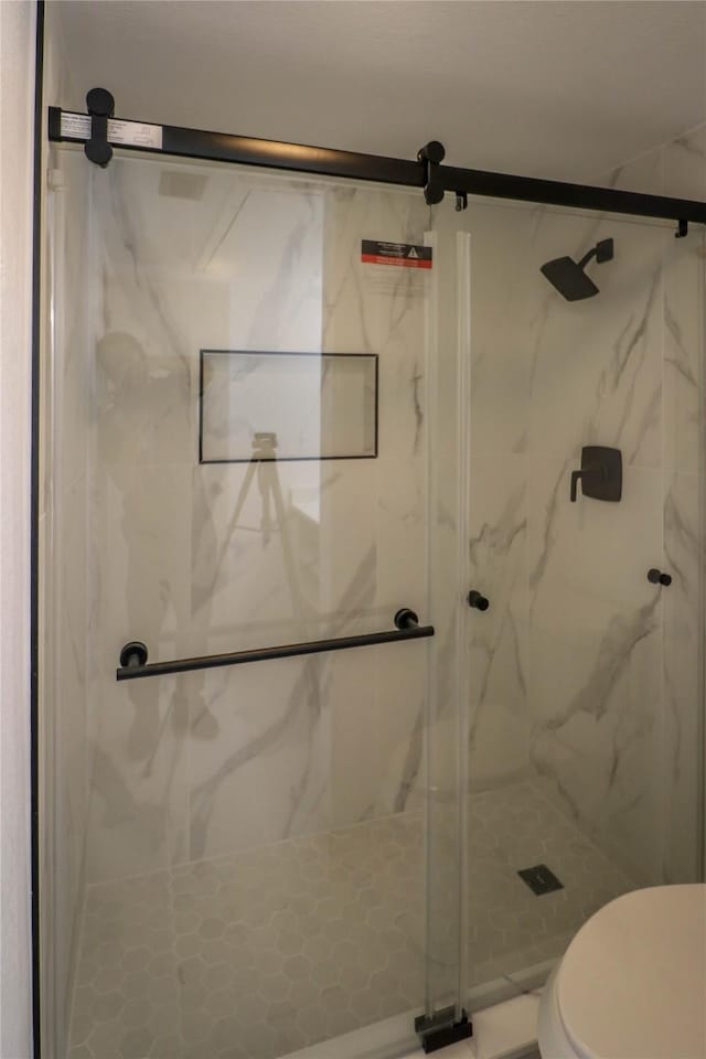 10578 High Hollows Dr Unit 166, Dallas, TX 75230 - bathroom featuring a marble finish shower and toilet