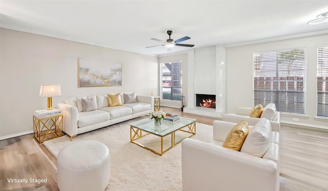 10578 High Hollows Dr Unit 166, Dallas, TX 75230 - living room featuring crown molding, wood finished floors, a ceiling fan, a fireplace, and baseboards