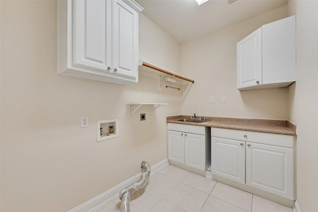 9122 Bottlebrush Ln, Irving, TX 75063 - laundry room with electric dryer hookup, hookup for a washing machine, baseboards, cabinet space, and light tile patterned floors