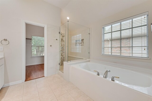 9122 Bottlebrush Ln, Irving, TX 75063 - bathroom featuring a bath, a shower stall, vanity, and tile patterned floors