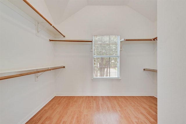 9122 Bottlebrush Ln, Irving, TX 75063 - walk in closet with wood finished floors and vaulted ceiling