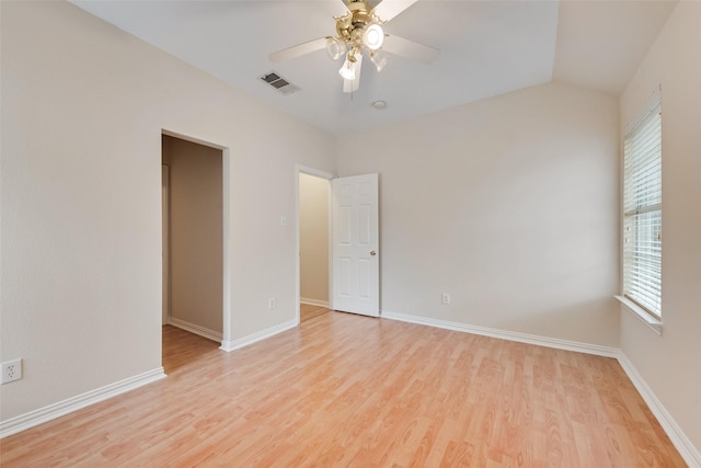 9122 Bottlebrush Ln, Irving, TX 75063 - empty room featuring light wood-style floors, a ceiling fan, baseboards, and vaulted ceiling