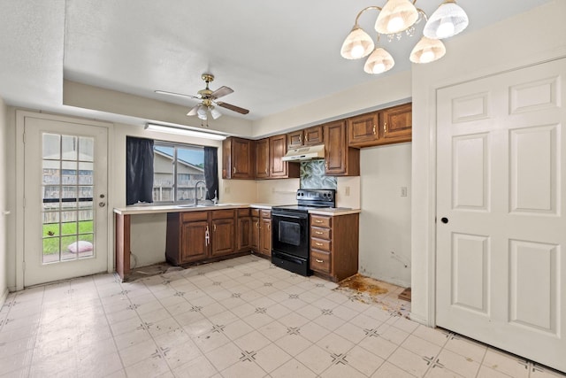 4006 Fletcher Dr, Garland, TX 75044 - kitchen featuring black range with electric stovetop, under cabinet range hood, a sink, light flooring, and light countertops