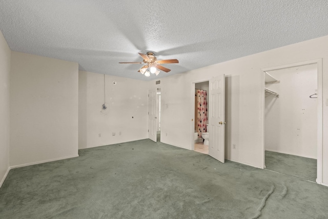 4006 Fletcher Dr, Garland, TX 75044 - unfurnished bedroom featuring a textured ceiling, carpet floors, a walk in closet, ensuite bathroom, and a ceiling fan