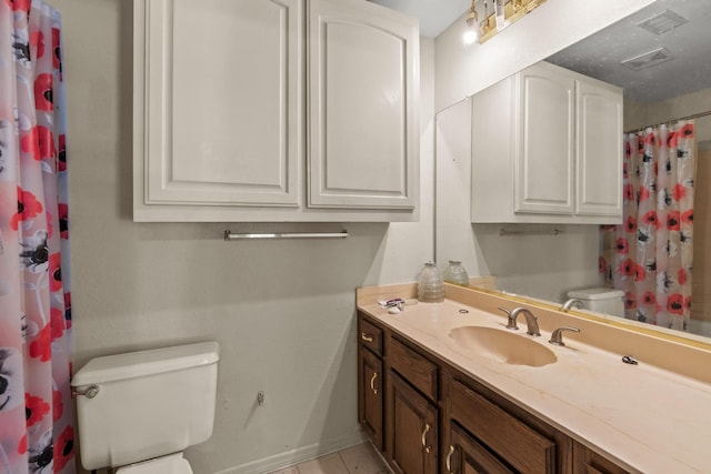 4006 Fletcher Dr, Garland, TX 75044 - bathroom featuring toilet, vanity, tile patterned floors, and baseboards