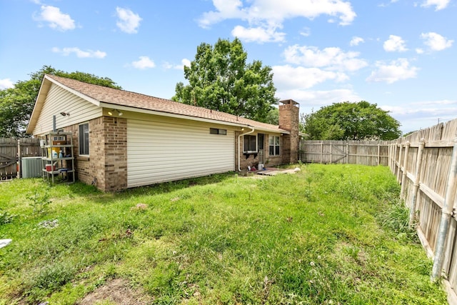 4006 Fletcher Dr, Garland, TX 75044 - rear view of property featuring brick siding, a chimney, and cooling unit