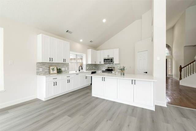 811 Chittamwood Ln, Allen, TX 75002 - kitchen with appliances with stainless steel finishes, light countertops, light wood-type flooring, decorative backsplash, and white cabinets
