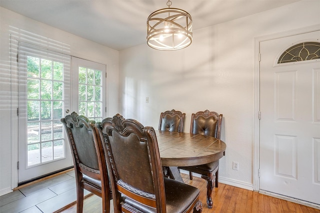 515 Euclid St, Cleburne, TX 76033 - dining area with a chandelier, wood finished floors, and baseboards
