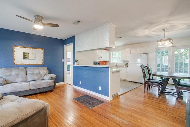515 Euclid St, Cleburne, TX 76033 - living area featuring light wood-style flooring, ceiling fan, and baseboards