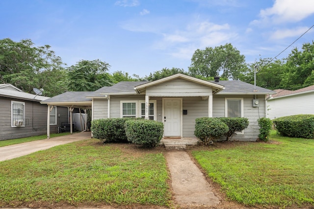 5340 Bourquin St, Dallas, TX 75210 - bungalow-style home with a front lawn, concrete driveway, an attached carport, and roof with shingles