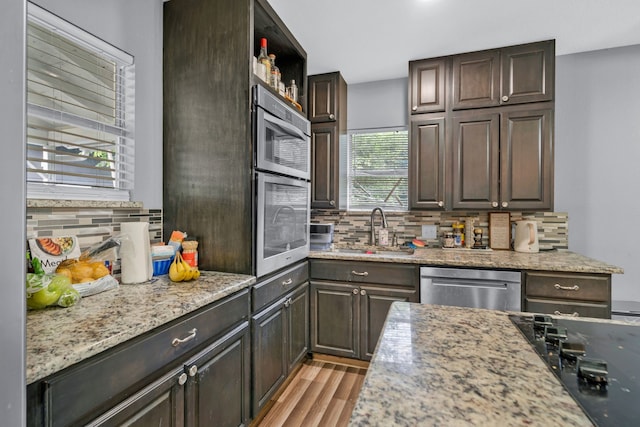 5340 Bourquin St, Dallas, TX 75210 - kitchen with dishwasher, a sink, tasteful backsplash, black electric stovetop, and light wood finished floors