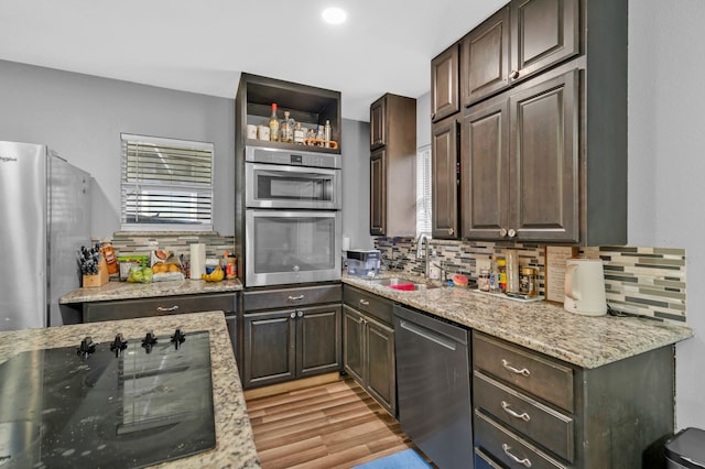 5340 Bourquin St, Dallas, TX 75210 - bar featuring appliances with stainless steel finishes, decorative backsplash, a sink, light wood-style floors, and recessed lighting