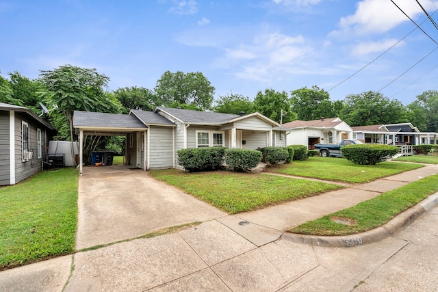 5340 Bourquin St, Dallas, TX 75210 - view of front of home featuring concrete driveway, a front yard, and a carport