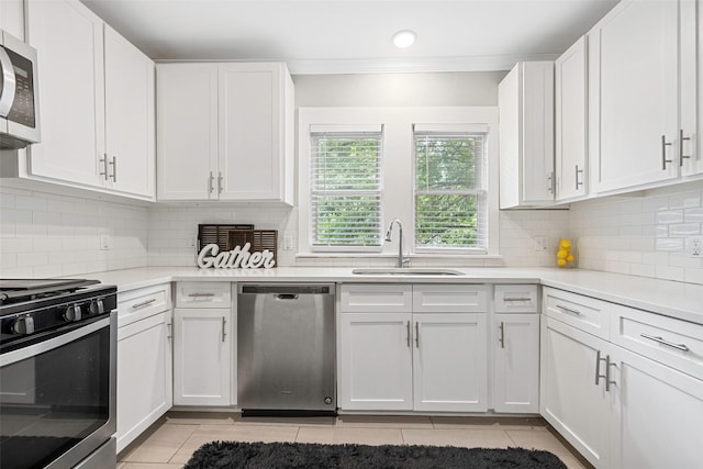 4742 Victor St, Dallas, TX 75246 - kitchen with stainless steel appliances, light tile patterned floors, white cabinetry, crown molding, and recessed lighting