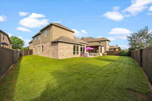 123 Deverson Dr, Rockwall, TX 75087 - back of property with brick siding, a patio area, and a shingled roof