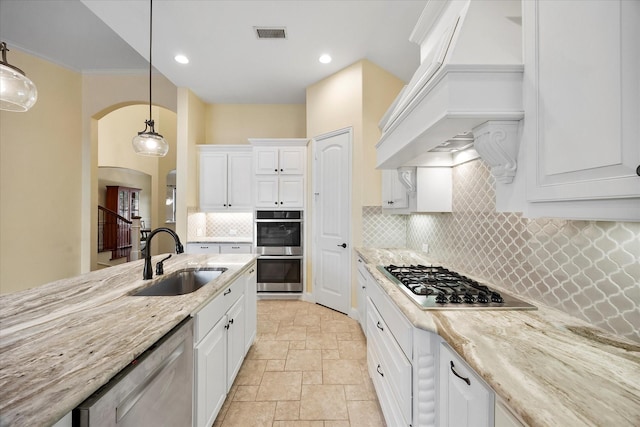 123 Deverson Dr, Rockwall, TX 75087 - kitchen with stainless steel appliances, a sink, stone tile floors, custom exhaust hood, and white cabinetry