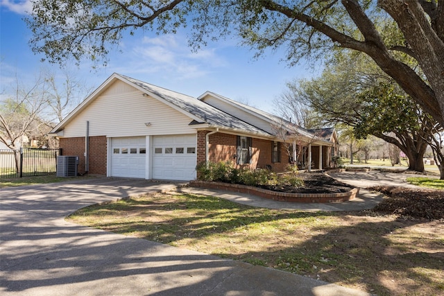 1205 Cross Timber Dr, Southlake, TX 76092 - view of home's exterior with brick siding, an attached garage, central AC unit, and driveway