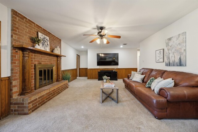 1205 Cross Timber Dr, Southlake, TX 76092 - living area featuring a brick fireplace, a wainscoted wall, a ceiling fan, carpet flooring, and wooden walls