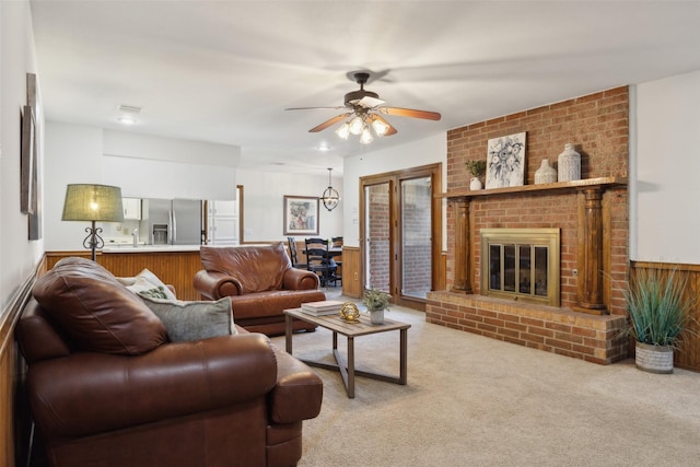1205 Cross Timber Dr, Southlake, TX 76092 - living room with light carpet, ceiling fan, a brick fireplace, and a wainscoted wall