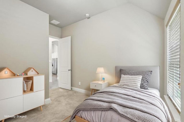 7817 Fossil Creek Trl, Mckinney, TX 75071 - bedroom featuring light colored carpet, baseboards, stainless steel fridge, and lofted ceiling