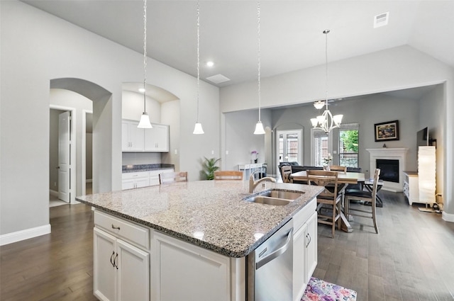 7817 Fossil Creek Trl, Mckinney, TX 75071 - kitchen featuring dishwasher, a sink, dark wood-style flooring, a center island with sink, and arched walkways