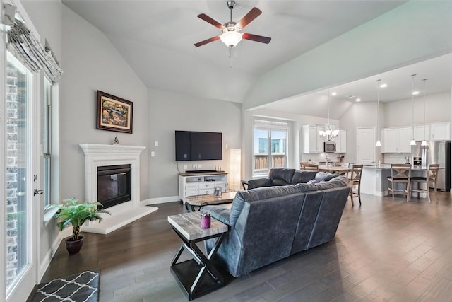 7817 Fossil Creek Trl, Mckinney, TX 75071 - living room with vaulted ceiling, dark wood-type flooring, a glass covered fireplace, ceiling fan, and recessed lighting