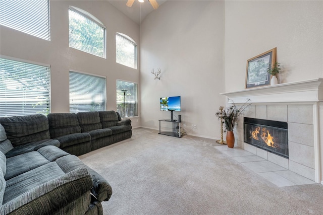 7908 Peacock Ln, Frisco, TX 75035 - living area featuring carpet floors, high vaulted ceiling, a tile fireplace, ceiling fan, and baseboards