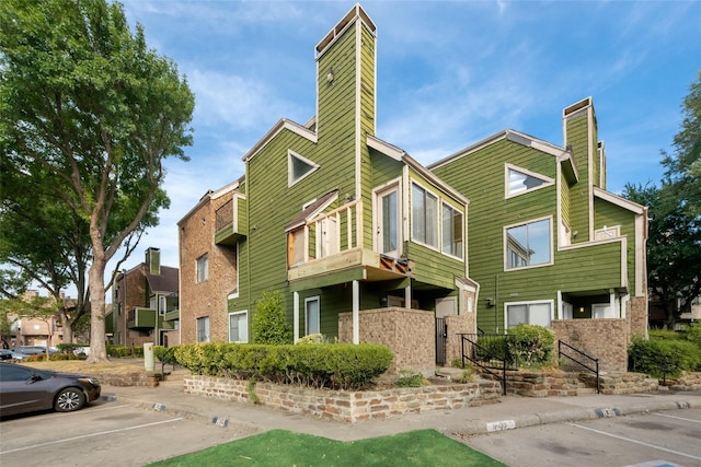 9815 Walnut St Unit 204, Dallas, TX 75243 - view of property featuring uncovered parking