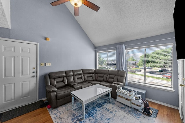 9815 Walnut St Unit 204, Dallas, TX 75243 - living room with lofted ceiling, ceiling fan, wood finished floors, a textured ceiling, and baseboards