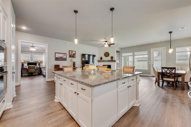 2208 Clancy Dr, Northlake, TX 76247 - kitchen featuring ceiling fan, a fireplace, a desk, light wood-type flooring, and recessed lighting