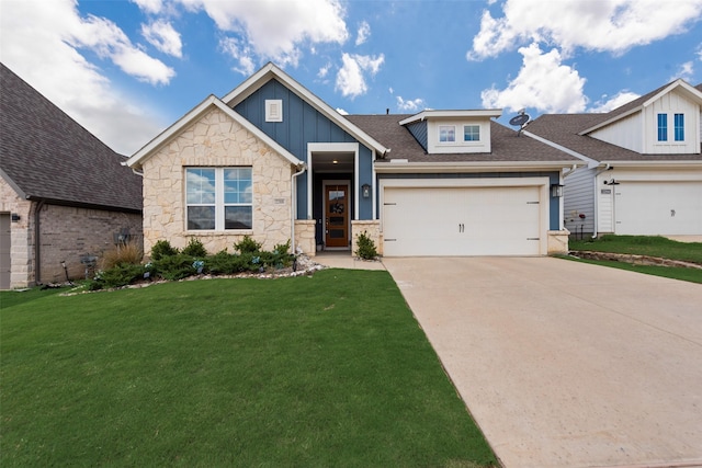 2208 Clancy Dr, Northlake, TX 76247 - view of front of house featuring board and batten siding, a front yard, concrete driveway, an attached garage, and stone siding