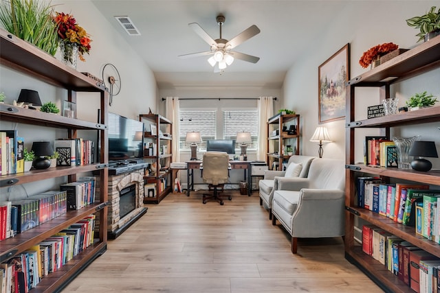 2208 Clancy Dr, Northlake, TX 76247 - home office with ceiling fan, wood finished floors, and a fireplace