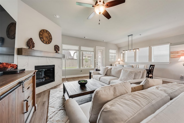 2208 Clancy Dr, Northlake, TX 76247 - living room featuring light wood finished floors, a fireplace, a ceiling fan, and baseboards