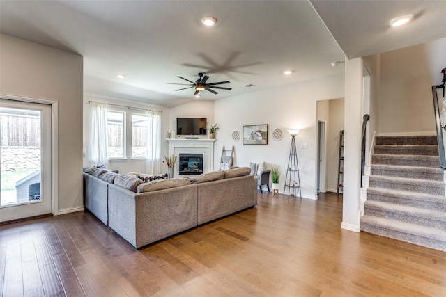 1312 Hutchings Ct, Celina, TX 75009 - living room with a ceiling fan, a glass covered fireplace, stairs, wood finished floors, and baseboards