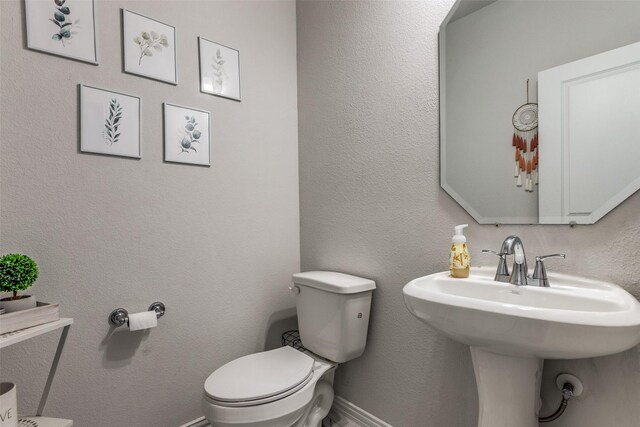 1312 Hutchings Ct, Celina, TX 75009 - bathroom featuring toilet, a sink, and baseboards