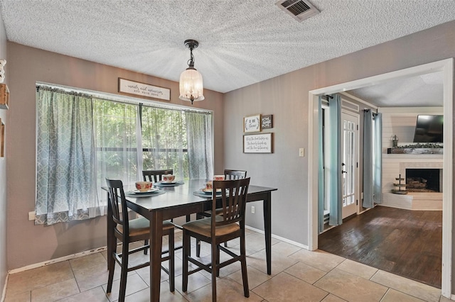 4109 Three Oaks Dr, Arlington, TX 76016 - dining space with tile patterned floors, a chandelier, baseboards, and a textured ceiling