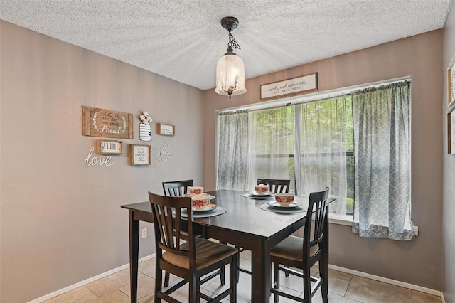 4109 Three Oaks Dr, Arlington, TX 76016 - dining room featuring plenty of natural light, light tile patterned floors, a textured ceiling, and baseboards