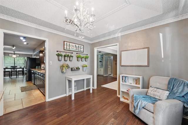 4109 Three Oaks Dr, Arlington, TX 76016 - sitting room with a chandelier, crown molding, baseboards, a textured ceiling, and light wood finished floors