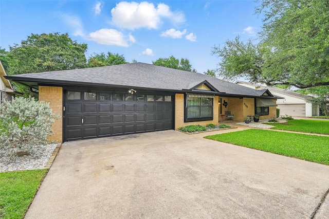 4109 Three Oaks Dr, Arlington, TX 76016 - view of front of home featuring concrete driveway, a garage, brick siding, a front yard, and roof with shingles