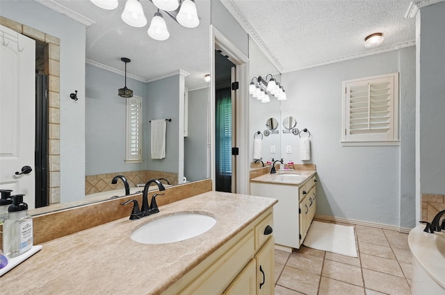 4109 Three Oaks Dr, Arlington, TX 76016 - bathroom with two vanities, a textured ceiling, tile patterned floors, ornamental molding, and a chandelier