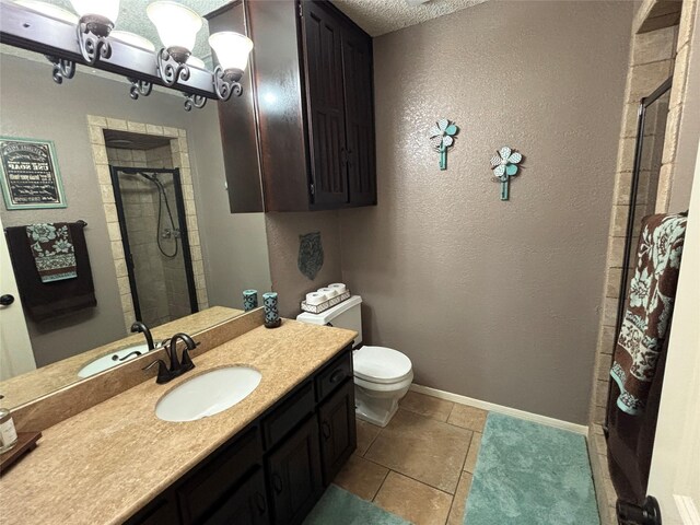 4109 Three Oaks Dr, Arlington, TX 76016 - full bath with a stall shower, toilet, vanity, baseboards, and a textured wall