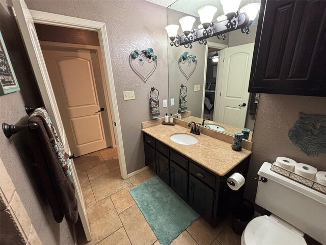 4109 Three Oaks Dr, Arlington, TX 76016 - bathroom featuring a textured wall, vanity, toilet, baseboards, and a chandelier