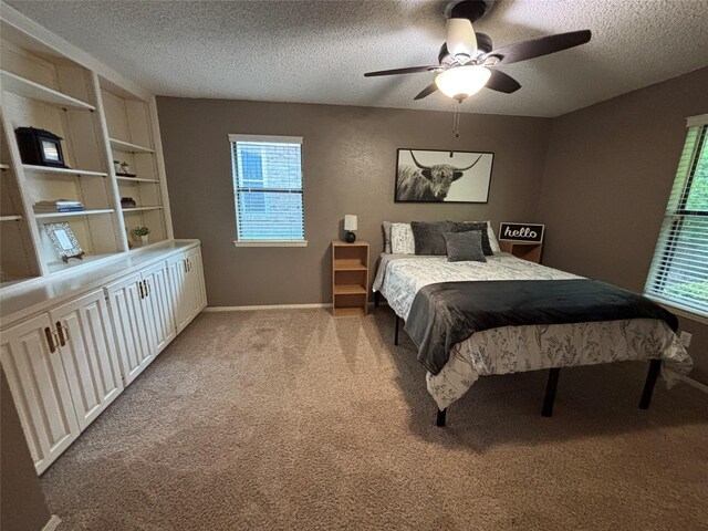 4109 Three Oaks Dr, Arlington, TX 76016 - carpeted bedroom featuring a textured ceiling, multiple windows, ceiling fan, and baseboards