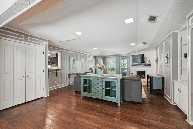 4109 Three Oaks Dr, Arlington, TX 76016 - kitchen featuring a fireplace, a textured ceiling, green cabinets, dark wood-type flooring, and recessed lighting