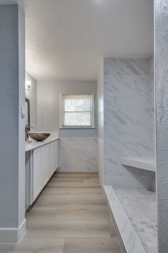 6720 Davidson St, Richland Hills, TX 76118 - full bath featuring vanity, a marble finish shower, wood finished floors, and a textured ceiling