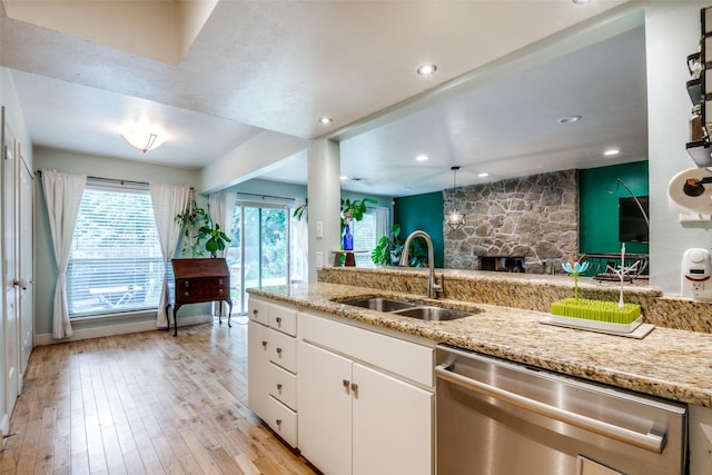 3964 Lost Creek Dr, Dallas, TX 75224 - kitchen featuring stainless steel dishwasher, light wood finished floors, white cabinetry, light stone counters, and recessed lighting